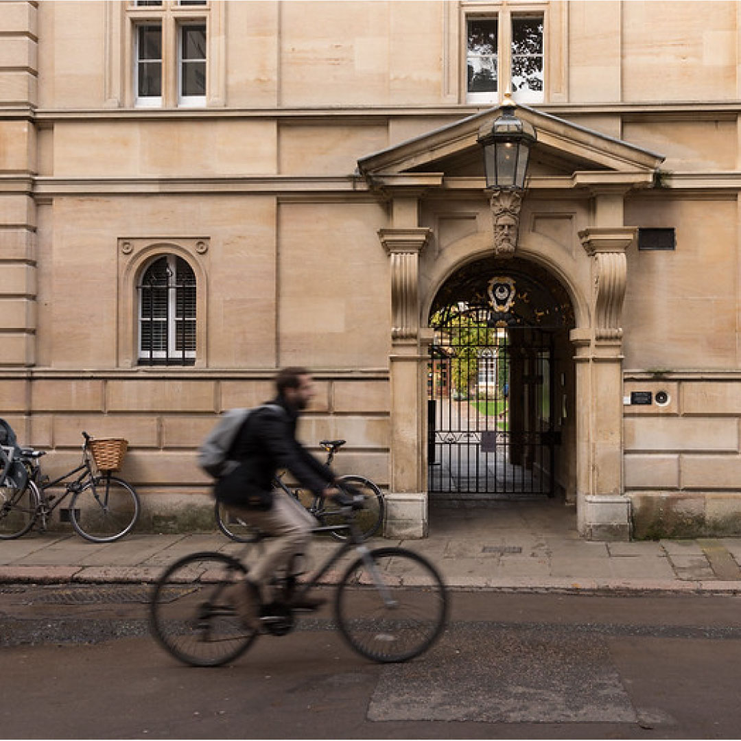 Man cycling past building